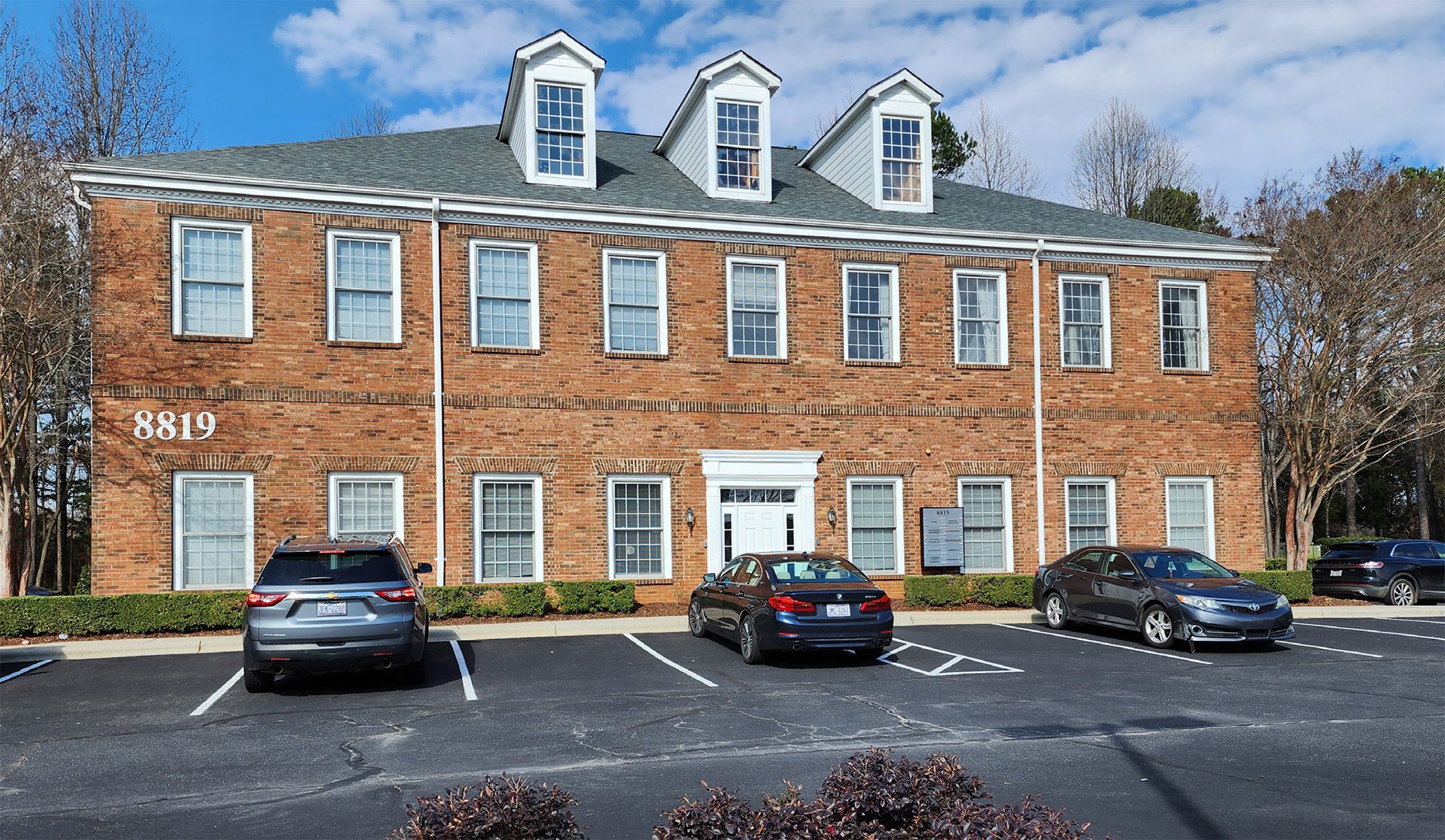 8819 University East exterior image 2-story brick office building