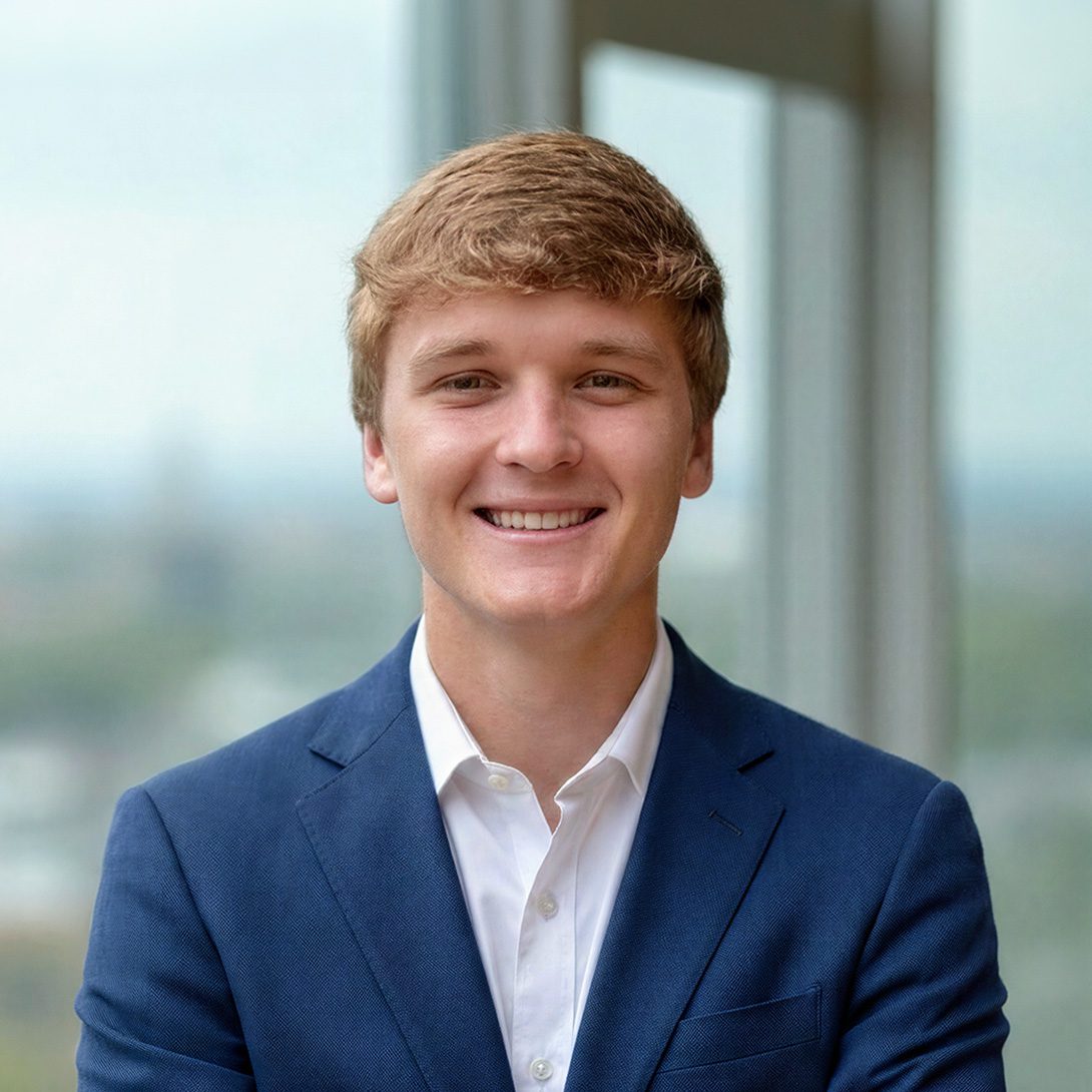 Leyton Starks young man with blond hair standing by window in a blue jacket and white collar shirt