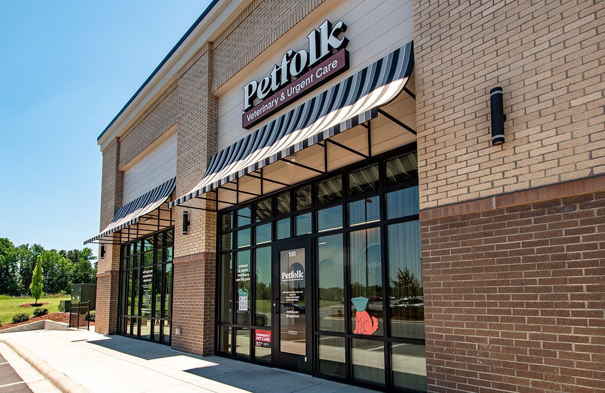 Petfolk storefront with striped awning and brick facade in Concord