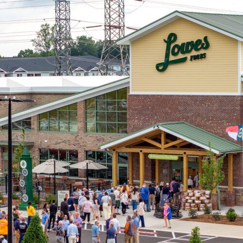 Lowes Foods grand opening view from outside with crowd of people walking into the store
