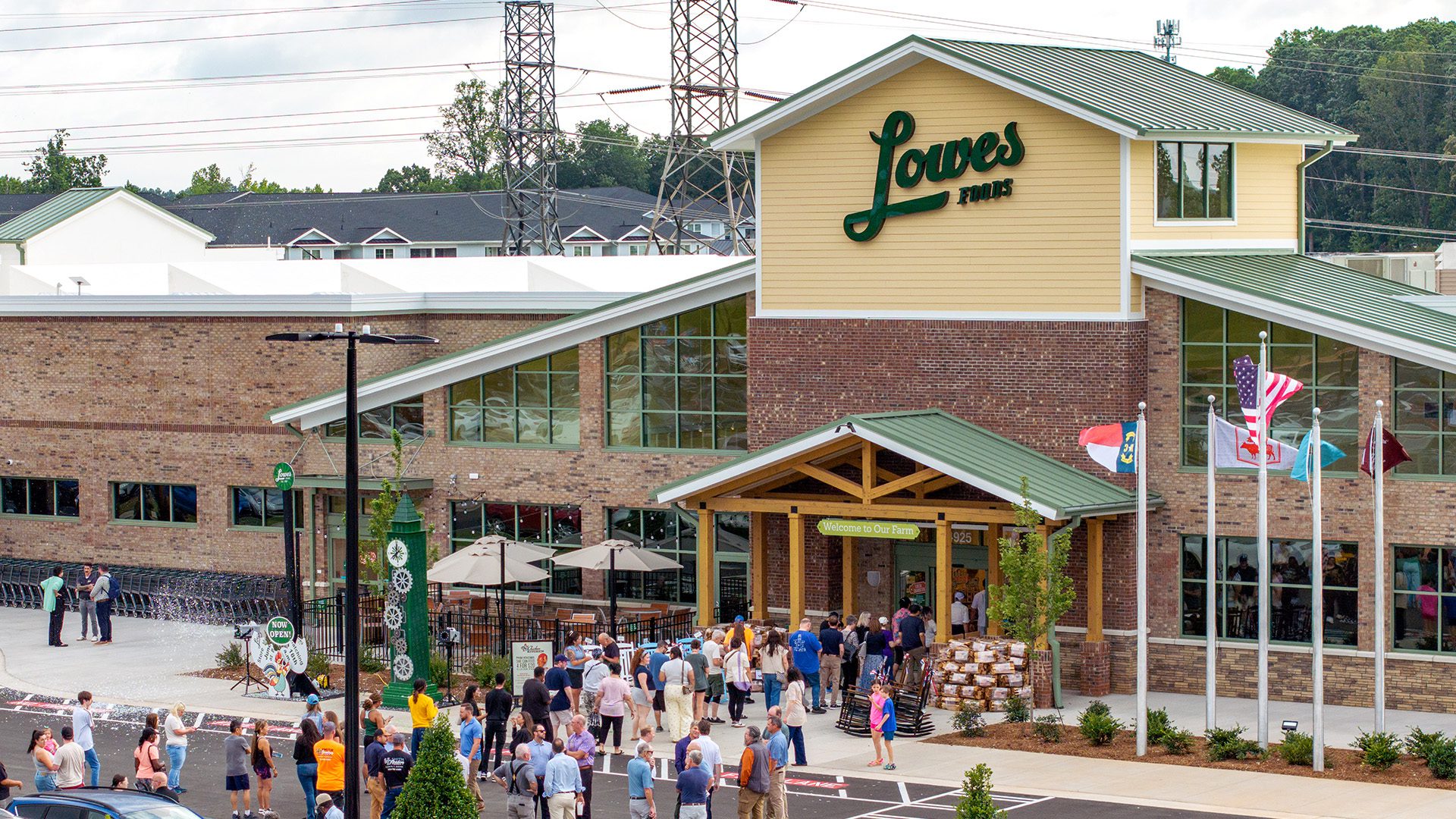Lowes Foods grand opening view from outside with crowd of people walking into the store