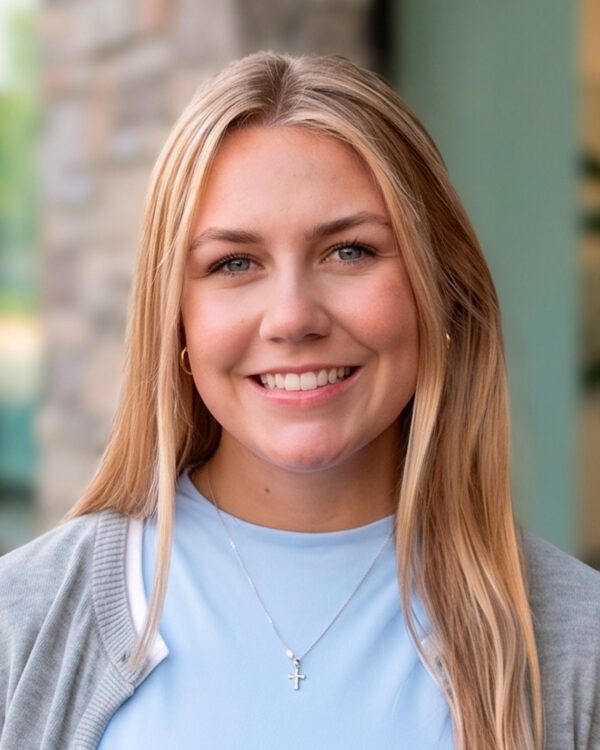 Georgia Arnold young smiling woman in office setting with long blonde hair