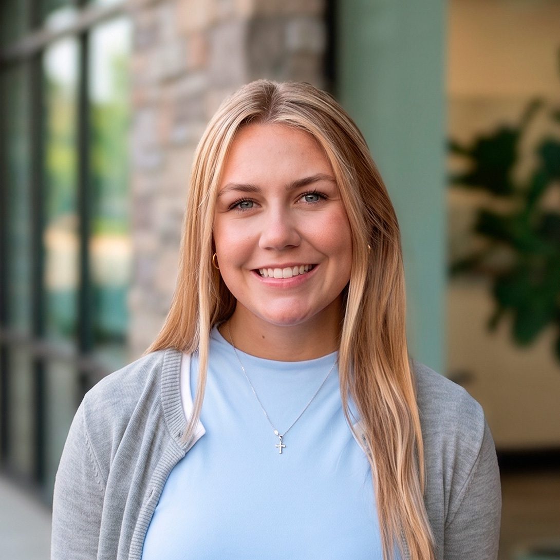Georgia Arnold young smiling woman in office setting with long blonde hair
